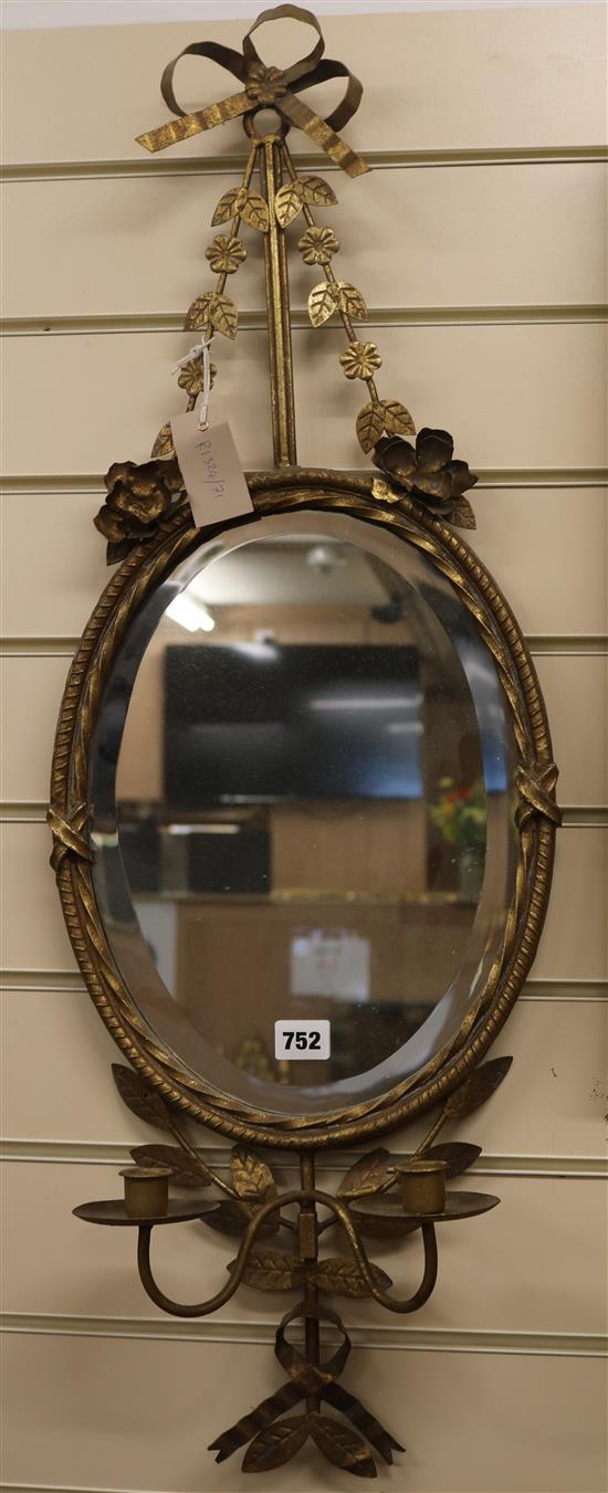 An oval mirror with ribbon crest H.85cm